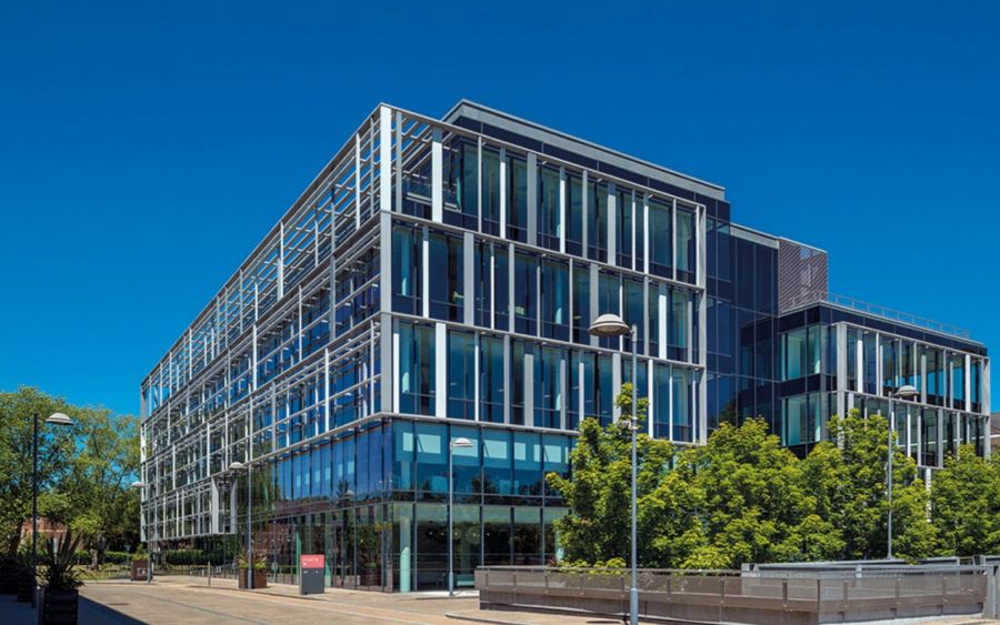 A modern office building against a blue sky backdrop